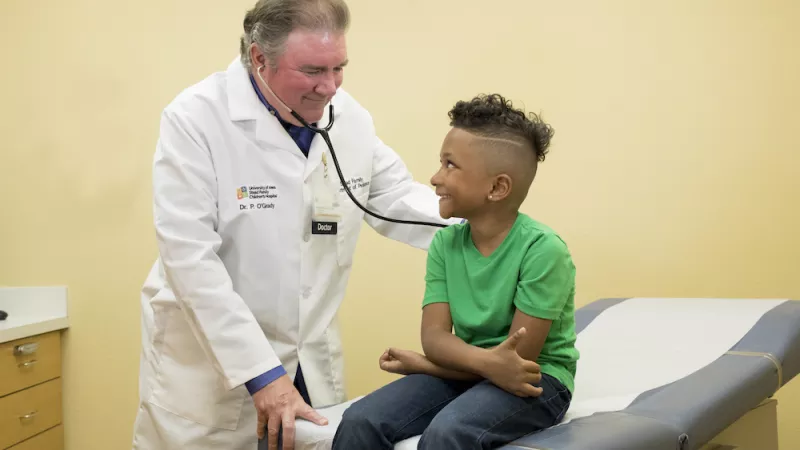 Pediatrician caring for child